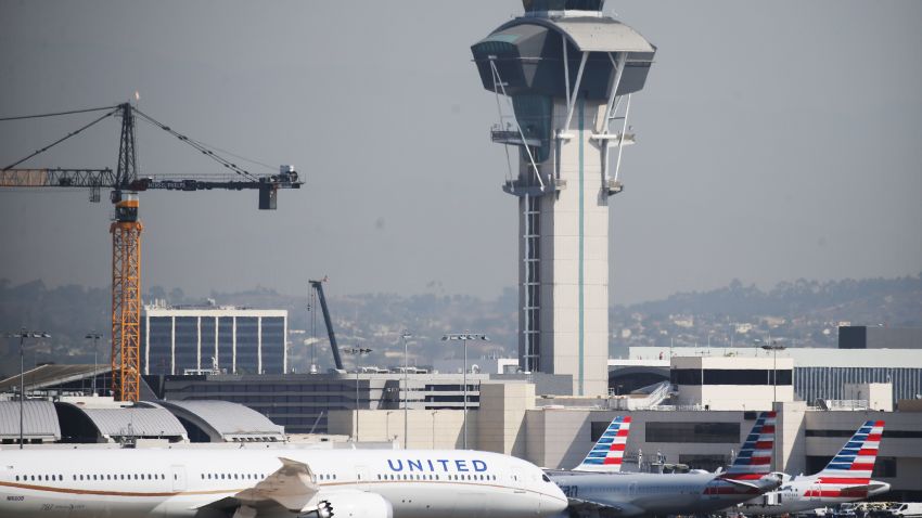 LOS ANGELES, CALIFORNIA - OCTOBER 01: A United Airlines plane taxis past American Airlines planes on the tarmac at Los Angeles International Airport (LAX) on October 1, 2020 in Los Angeles, California. United Airlines and American Airlines are set to start furloughing 32,000 employees today after negotiations for a new coronavirus aid package failed in Washington. (Photo by Mario Tama/Getty Images)