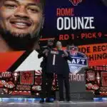 Washington wide receiver Rome Odunze, left, poses with NFL Commissioner Roger Goodell after being chosen by the Chicago Bears with the ninth overall pick during the first round of the NFL football draft, Thursday, April 25, 2024, in Detroit. (AP Photo/Jeff Roberson)