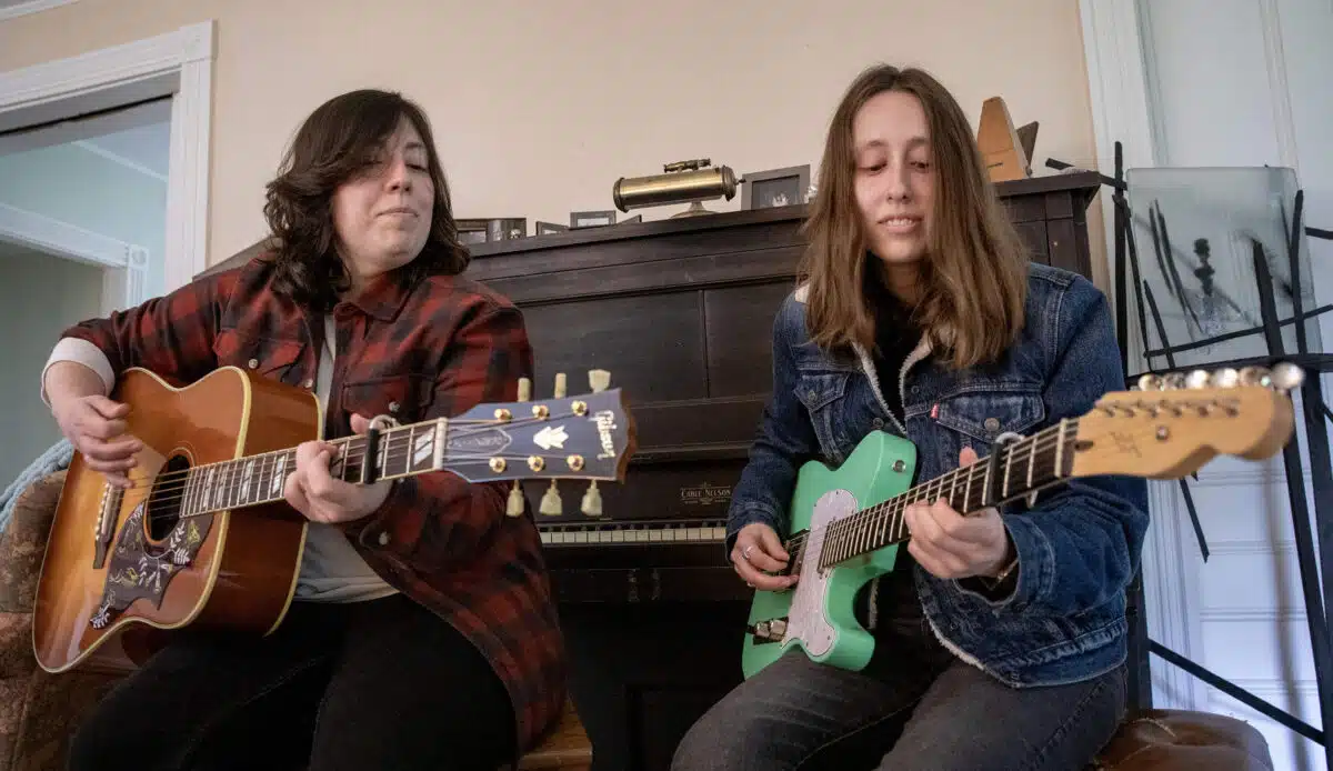 Rebecca and Rachael Wolff play songs together at their family home Canton, Mass. (Robin Lubbock/WBUR)